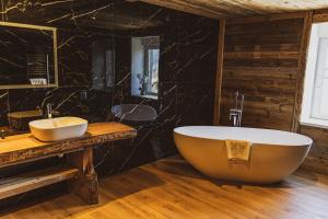a bathroom with a large tub and a sink at La Charbonnière, grand gîte haut-de-gamme avec jacuzzi et sauna in Gérardmer +46 photos