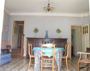 a dining room with a table and chairs at Demeure de la pompe in La Queue-en-Brie +6 photos