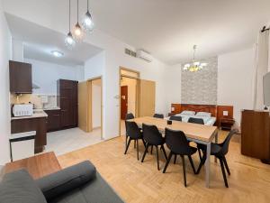 a living room and dining room with a table and chairs at K13 Gozsdu Apartment in Budapest