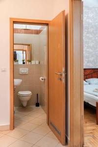 a bathroom with a toilet and a sink at K13 Gozsdu Apartment in Budapest +22 photos