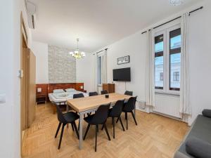 a dining room with a table and chairs at K13 Gozsdu Apartment in Budapest