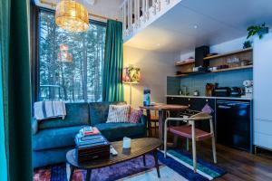 a living room with a couch and a table at Lahepere Villa mini-villad in Kloogaranna