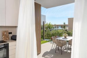 a kitchen and dining room with a table and chairs at Villa Valea - Managed by Excelsior Villas in Turanj