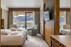 a hotel room with two beds and a balcony at TatryTop Giewont House Wellness in Kościelisko