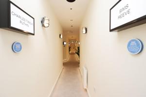 a hallway of a hospital with signs on the walls at Albert Hall 1 Bed ApartHotel- Food & Bar Onsite in Swansea