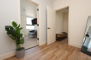 a living room with a mirror and a chair at Albert Hall 1 Bed ApartHotel- Food & Bar Onsite in Swansea