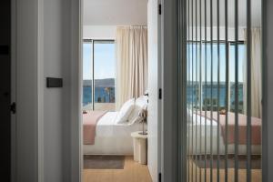 a bedroom with a bed and a view of the ocean at Villa Valea - Managed by Excelsior Villas in Turanj +61 photos