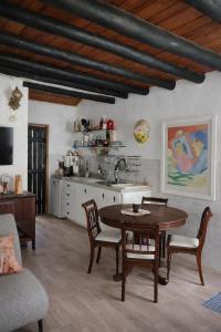 a kitchen with a table and chairs in a room at Pousada da Janjana in Nova Iguaçu