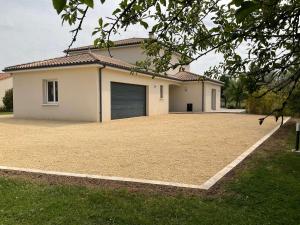 a house with a large driveway in front of it at L Ecrin d Anabelle in Saint-Georges-lès-Baillargeaux