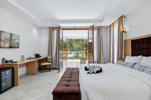 a bedroom with a bed and a desk and a television at OSOTUA Villa 18 Home Hotel Nanyuki 7 Bedrooms 14 Guests in Nanyuki