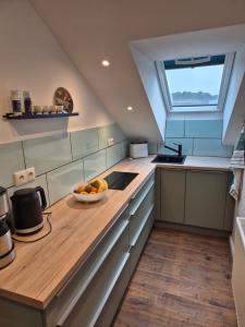 a kitchen with a bowl of fruit on a counter at # Ausblick LübEck in Lübeck