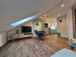 a living room with a television and a table and chairs at # Ausblick LübEck in Lübeck