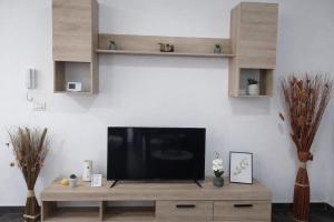 a flat screen tv sitting on top of a wooden entertainment center at Hera Exclusive Stay 2 in Timişoara