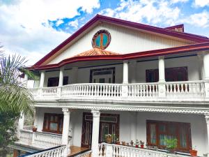 a white house with a red roof at White House Benguet in Sablan