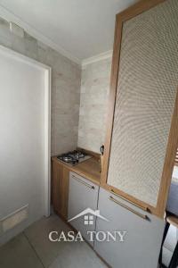 a small kitchen with a stove and a refrigerator at Casa Tony Natales in Puerto Natales