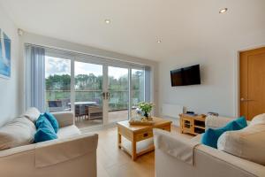 a living room with two couches and a large window at 2 Bed in Brixham oc-bc157 in Brixham