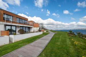 a house with a walkway next to the water at 2 Bed in Brixham oc-bc157 in Brixham
