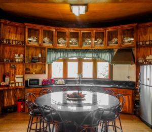 a kitchen with a table and chairs in it at White House Benguet in Sablan