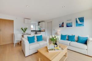 a living room with two white couches and blue pillows at 2 Bed in Brixham oc-bc157 in Brixham