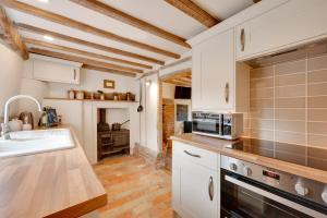 a kitchen with white cabinets and a sink at 2 Bed in Saxtead oc-pera in Saxtead +5 photos