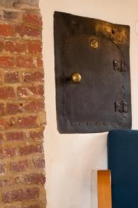 a door on a wall next to a brick wall at 2 Bed in Saxtead oc-pera in Saxtead