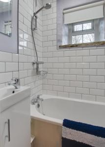 a white bathroom with a tub and a sink at 2 Bed in Hawes oc-ds042a in Hawes
