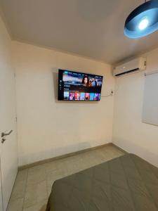 a room with a flat screen tv on the wall at Cabaña 36 termas in Chajarí