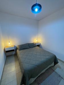 a bedroom with a bed and two night stands at Cabaña 36 termas in Chajarí