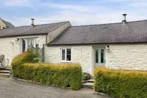 a white house with bushes in front of it at 2 Bed in Carmel oc-wai211 in Llanerchymedd
