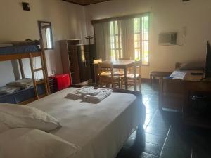 a bedroom with a bed and a dining room with a table at Casona Rural alquiler temporal in Puerto Rico