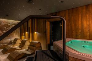 a jacuzzi tub in a room with chairs at TatryTop Giewont House Wellness in Kościelisko