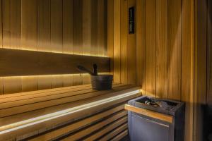 a sauna with a bucket on the ledge of a window at TatryTop Giewont House Wellness in Kościelisko