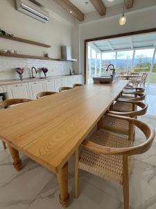 a large wooden table in a kitchen with chairs at 蘇西好日子別墅 in Sanxing +21 photos