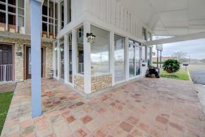 an empty porch of a house with glass doors at Cannon Inn By Capital O Gonzales Tx in Gonzales