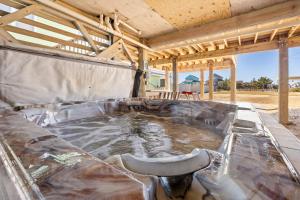 a hot tub with a chair in the middle at 6129 - Lady Jane in Nags Head