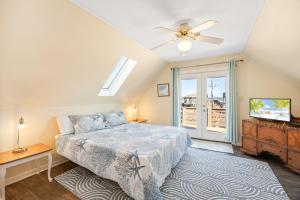 a bedroom with a bed and a flat screen tv at 6129 - Lady Jane in Nags Head