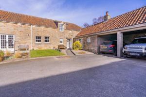 a car parked in the garage of a brick house at 3 Bed in Kingsbarns oc-k30925 in Kingsbarns