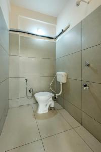 a bathroom with a toilet and a shower at Grape Rooms in Perintalmanna +19 photos