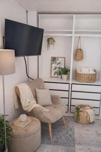 a living room with a chair and a lamp at Das Litzldorf in Sankt Michael im Lungau