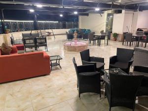 a large room with chairs and tables and a fountain at Suzan Hotel Apartments in Amman