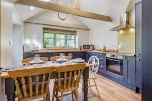 a kitchen with a table and chairs in a kitchen at 3 Bed in Cley oc-t32433 in Cley next the Sea