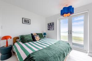 a bedroom with a bed and a large window at 4 Bed in Saltdean oc-a32366 in Saltdean
