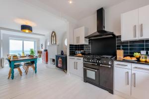 a kitchen with a stove and a table in it at 4 Bed in Saltdean oc-a32366 in Saltdean +26 photos