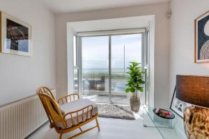 a living room with a chair and a glass table at 4 Bed in Saltdean oc-a32366 in Saltdean
