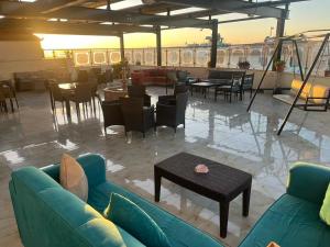 a living room with a couch and tables and chairs at Suzan Hotel Apartments in Amman