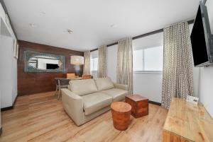 a living room with a couch and a table at Metropole Suites South Beach in Miami Beach