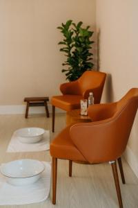 two orange chairs and a table in a room at Promenade Palladium Leblon in Rio de Janeiro +20 photos