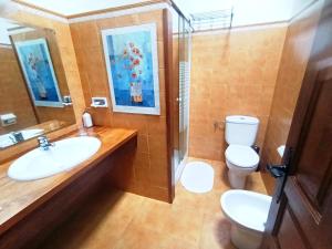 a bathroom with a sink and a toilet at Casona de Gómez y Terán in Renedo +17 photos