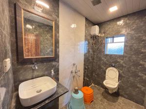 a bathroom with a sink and a toilet at Aroma Residency 2bhk villa & delux rooms in Mahabaleshwar +20 photos
