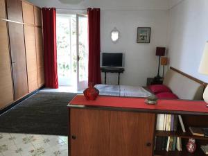 a bedroom with a bed with a red counter top at Casa Anna Capri Charme in Capri